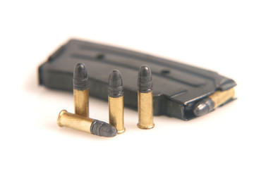 .22 rifle magazine with bullets on a white background.