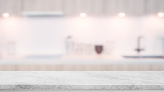 Empty white marble stone table top and blurred kitchen interior background with vintage filter - can used for display or montage your products.