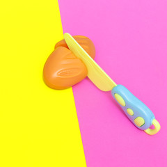 Toy plastic bread. Minimal flat lay food art