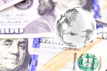 business finance concept in sphere globe and money, dollars bankonotes