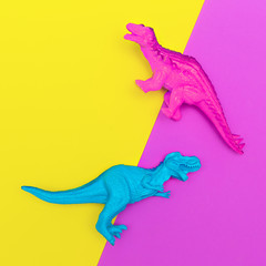 Plastic dinosaurs on a colored background. Minimal flat lay art