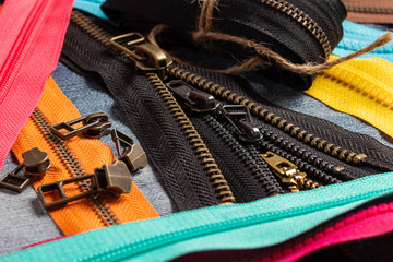 Pack a lot of colorful plastic and metal zippers stripes with sliders pattern for handmade sewing...