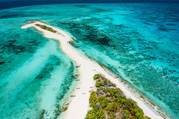 Truly amazing tropical island in the middle of the ocean. Aerial view of an island with white sand beaches and beautiful lagoons