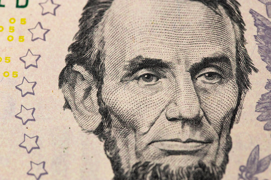 Abraham Linkoln portrait. 5 US dollars banknote closeup macro.