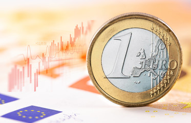closeup one euro coin with digital chart on the euro bankontes background