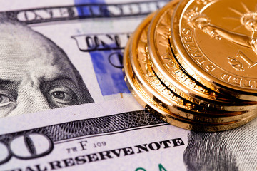 closeup stack dollars golden coins and hundred dollars banknotes