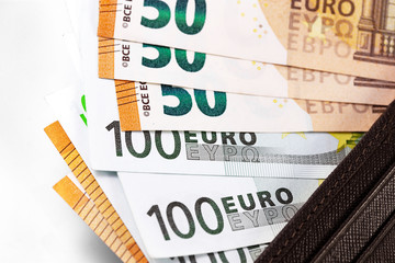 closeup stack euro banknotes in wallet on the white background