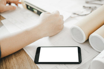 Mockup image of engineers using smartphone to drawing design building Project in office, mockup concept