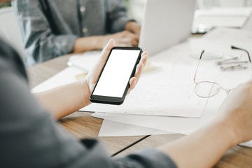 Mockup image of engineers using smartphone to drawing design building Project in office, mockup concept