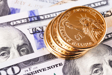 macro one dollar golden coins and hundred dollars banknotes
