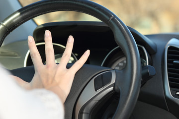 Car driver hand honking horn