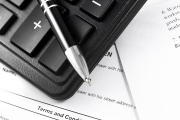 paperwork, black calculator and pen closeup
