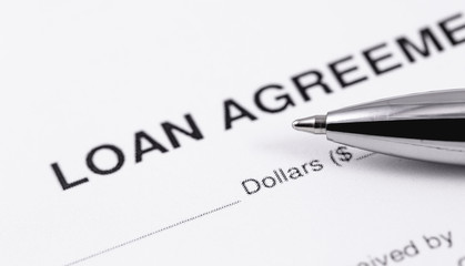 personal loan agreement application form with black pen closeup macro