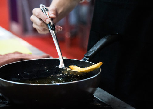 Chef Is Cooking French Fries In The Kitchen, Chef Cooking Fried Potato In Pan