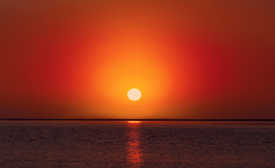 Beautiful  red sunset on the beach and sea