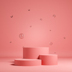 Pastel pink background for product presentation made of three cylinders with glass balls.