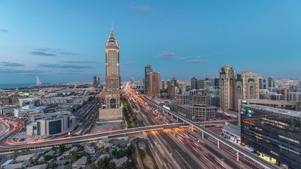 Skyline internet city with crossing Sheikh Zayed Road aerial day to night timelapse