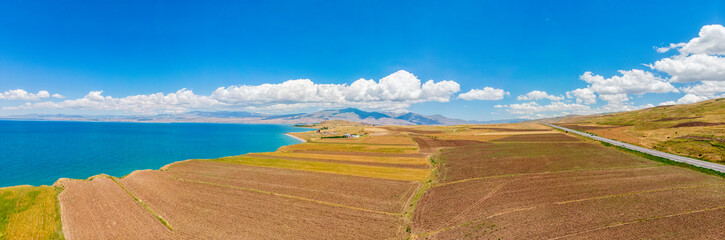 Aerial view of Lake Van the largest lake in Turkey, lies in the far east of that country in the provinces of Van and Bitlis. Fields and cliffs overlooking the crystal waters. Roads along the lake