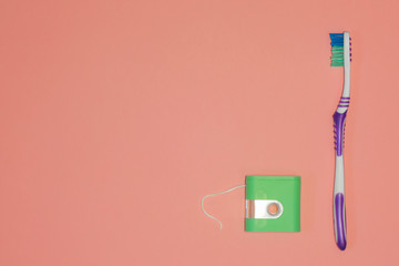 toothbrush and dental floss Living Coral Trend top view copy space