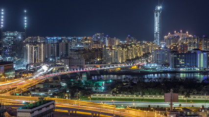 Fototapeta premium Palm Jumeirah Highway bridge aerial night timelapse. Dubai, United Arab Emirates