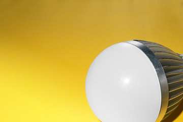 Powerful LED bulb lamp with cooling radiator closeup image. Concept poster of electricity, technologies, money saving and environment friendly utilities. Diode equipment is illuminated