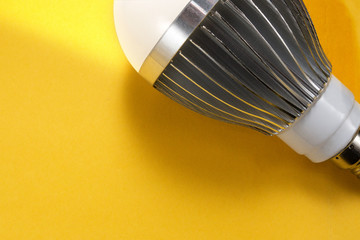 Powerful LED bulb lamp with cooling radiator closeup image. Concept poster of electricity, technologies, money saving and environment friendly utilities. Diode equipment is illuminated