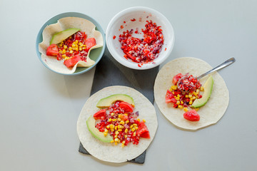 Mexican taco with vegetarian fillings on light table, cooking process
