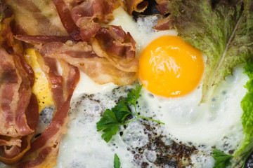 fried eggs for Breakfast close-up with bacon