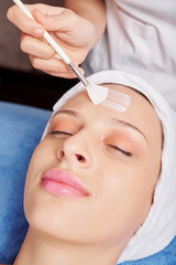 Attractive young Caucasian woman enjoying nourishing and moisturizing face mask