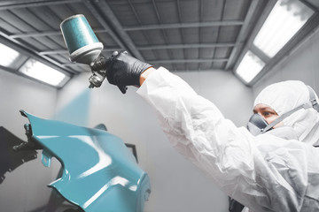 Application of first layer spray painting of the car fender.
