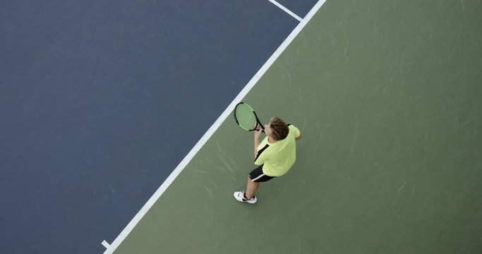 OVERHEAD CRANE Young Caucasian teenager male tennis player during a game or practice. Slow motion, 4K UHD RAW graded footage