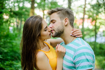 Couple in love kissing with passion outdoors. Man and woman attractive lovers romantic kiss. Passionate kiss concept. Giving kiss. Seduction and foreplay. Sensual kiss of lovely couple close up