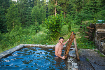 Young man in the pool with cold water.