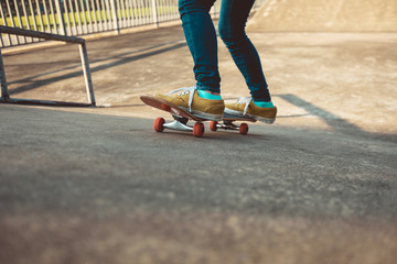 Fototapeta na wymiar Skateboard legs skateboarding at skatepark