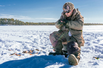 Naklejka premium winter fishing Fisherman enjoying a day on the ice