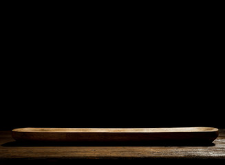 Wooden table background with black wall. Empty space for decoration and products.