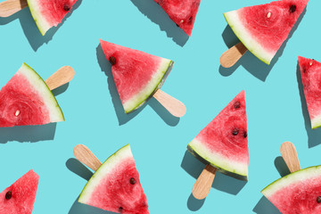 Flat lay top view of fresh watermelon slices on color background.