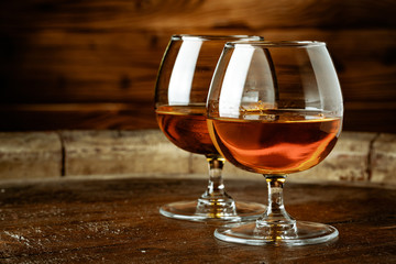 Two glasses of whiskey on a wooden table in the bar