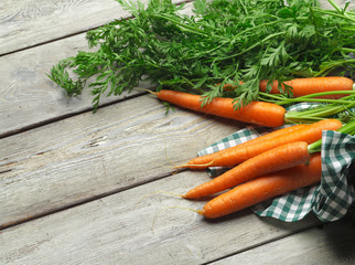 Close up of fresh carrot on rustic wooden background