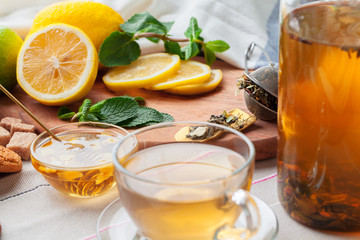 Chinese tea teapot lemon ginger honey on light tablecloth. Tea ceremony