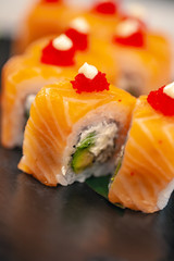 Healthy food. Japanese restaurant. Sushi roll on a black background