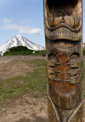 Detail of a wooden Gamul on Vilyuchinsky pass. Vilyuchik volcano in the background. Kamchatka Peninsula, Russia. Gamuls are mountain spirits, living on the hills, which produce rain and lightning.