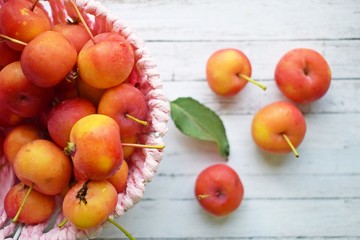 Naklejka na ściany i meble Delicious,ripe Ranetki-small apples on wooden background.