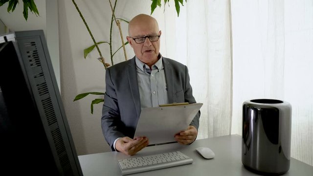 Boss Reading Performance Report Document and Throwing it Angrily