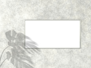 1x2 horizontal Chrome frame for photo or picture mockup on concrete background with shadow of monstera leaves. 3D rendering.