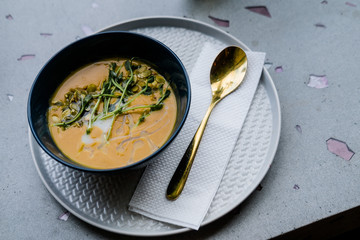 Pumpkin cream soup on light gray background