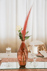 table setting in rose gold and pink feathers