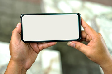 Hand-held images, smart phones, white background screens and bokeh backgrounds.