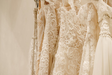 Cream wedding dresses hanging on the rack