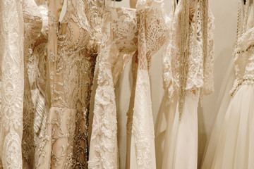 Cream wedding dresses hanging on the rack
